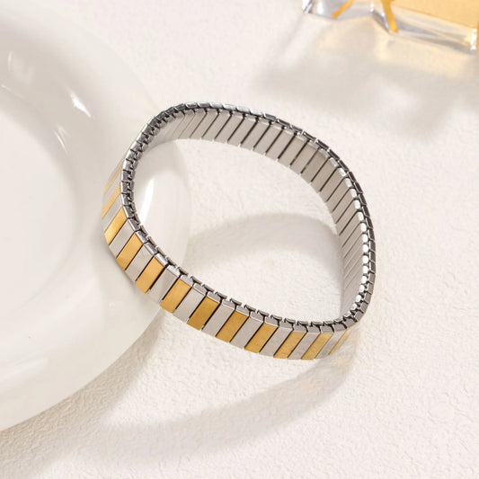 Pulsera estirable. Acero inoxidable. Bicolor, dorado con plata.
