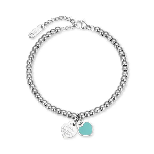 Pulsera tipo Tiffany con doble dije. Color plateado con dije color turquesa. Acero inoxidable.