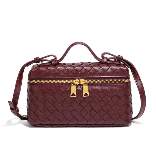 Bolsa rectangular, pequeña. Diseño entrelazado. Color vino con herrajes dorados.