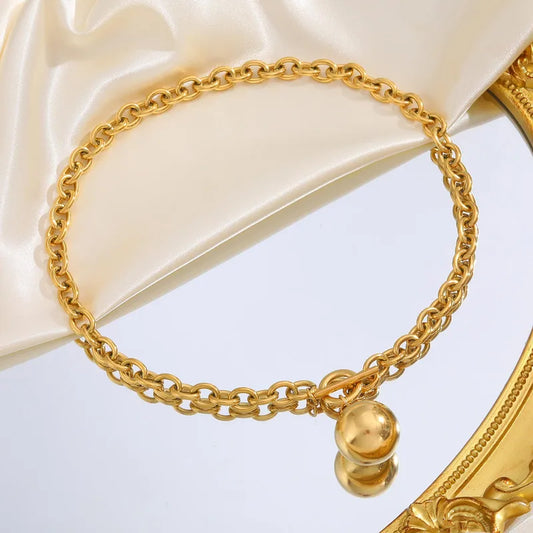 Collar de eslabones con dije de esfera. Color dorado. Acero inoxidable.