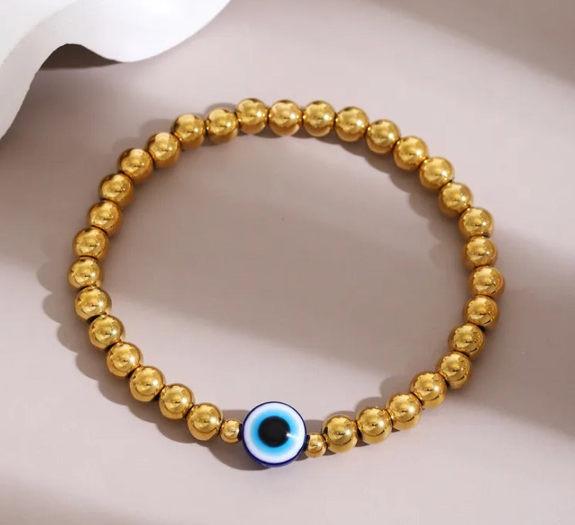 C10 - Pulsera bolas con ojo. Color dorado. Acero inoxidable.