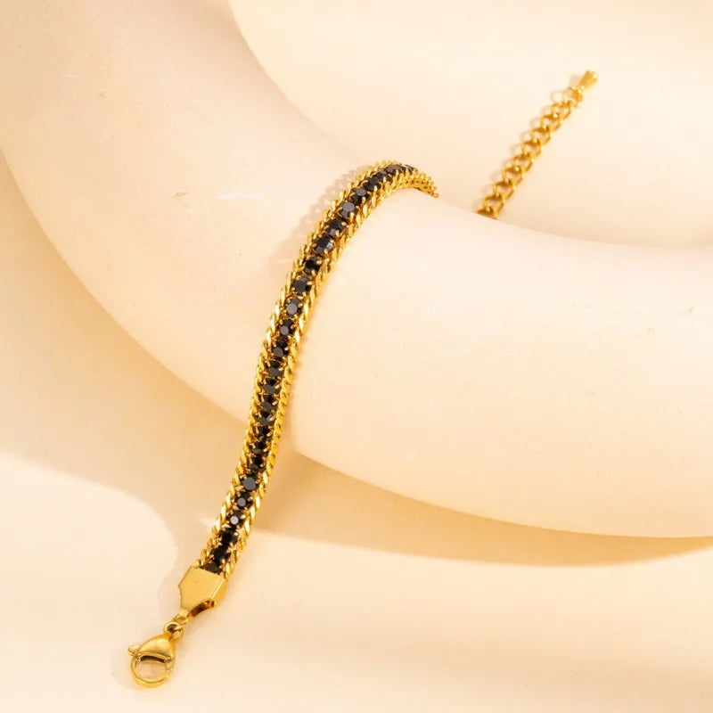 C16 - Pulsera con cristales negros. Color dorado. Acero inoxidable.