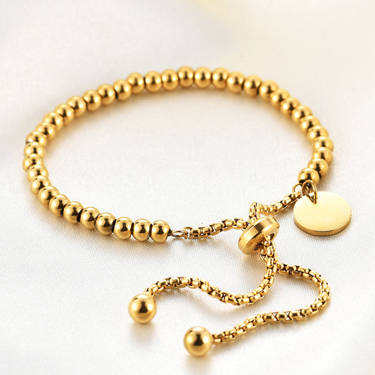 C20 - Pulsera bolitas, ajustable. Color dorado. Acero inoxidable.