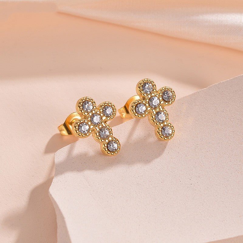 F20 - Aretes chicos de cruz con circonias. Color dorado. Acero inoxidable.