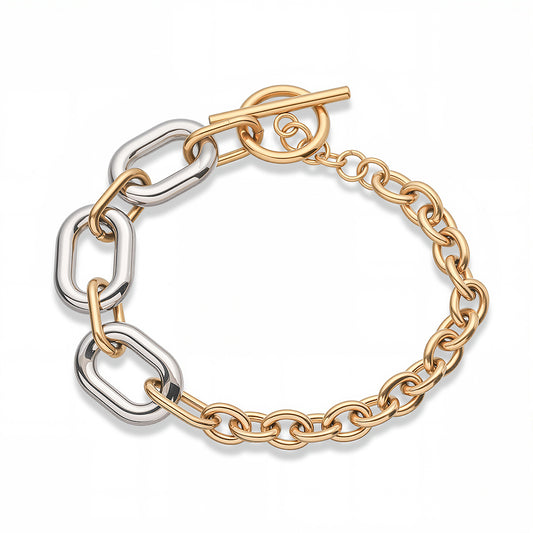 Pulsera gruesa. Color dorado con plateado. Acero inoxidable.