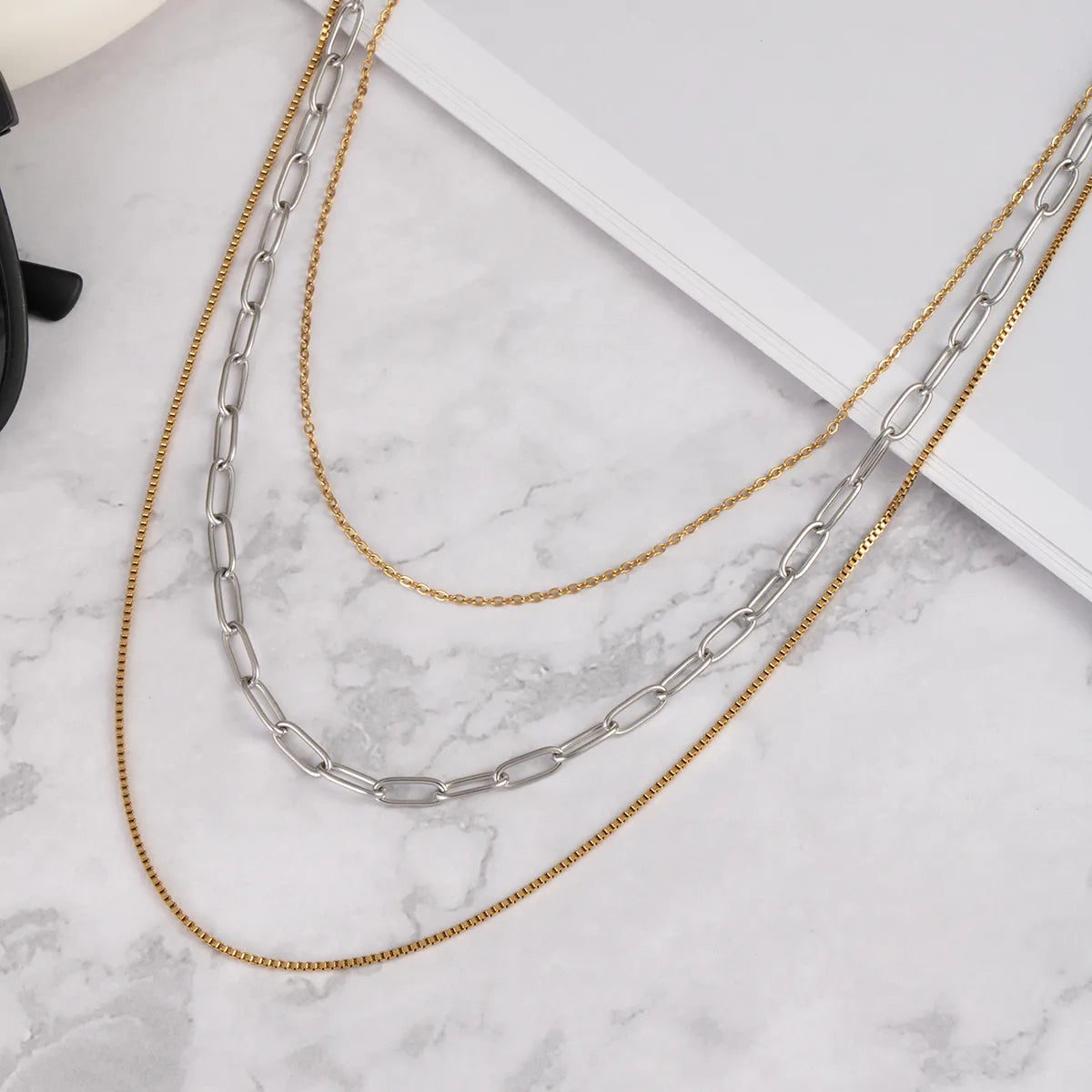 H10 - Collar triple. Color dorado y plateado. Color dorado. Acero inoxidable.