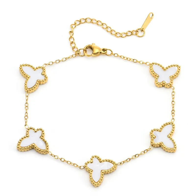 H16 - Pulsera con mariposas blancas. Color dorado. Acero inoxidable.