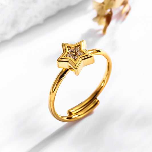 Anillo estrella con circonias, ajustable. Color dorado. Acero inoxidable.