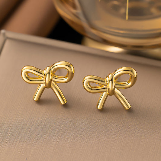 Aretes moño. Color dorado. Acero inoxidable.
